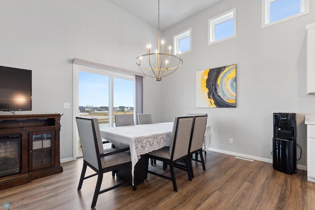 dining area featuring plenty of natural light, dark wood-type flooring, and high vaulted ceiling