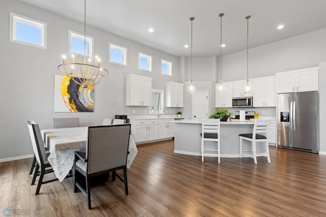 kitchen with a wealth of natural light, dark wood-type flooring, a kitchen island, and stainless steel appliances