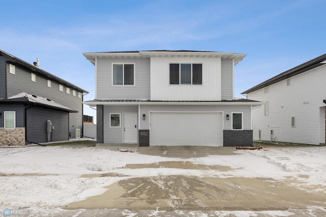 snow covered property featuring a garage