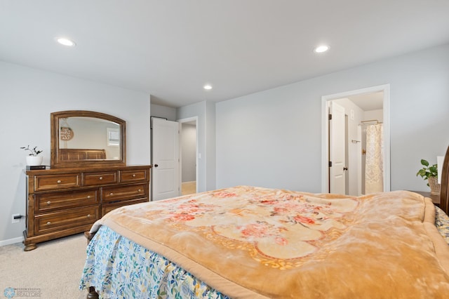 bedroom with carpet flooring and connected bathroom