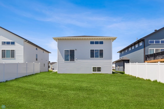 back of house with a yard