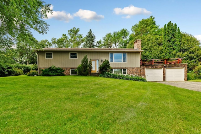 split foyer home featuring a front lawn and a garage