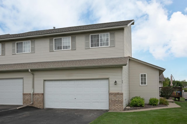 exterior space featuring a wooden deck and a garage