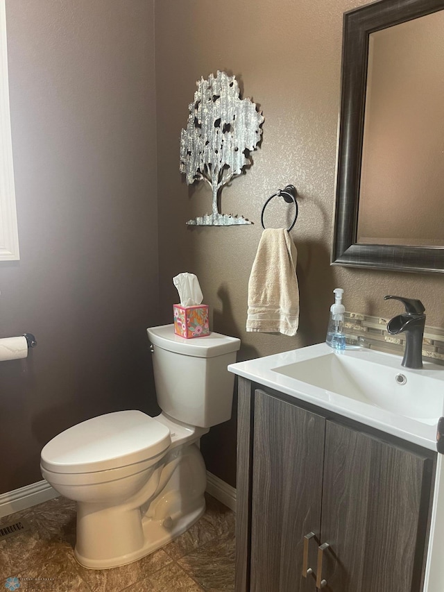 bathroom featuring vanity and toilet