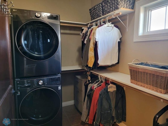 clothes washing area featuring stacked washing maching and dryer