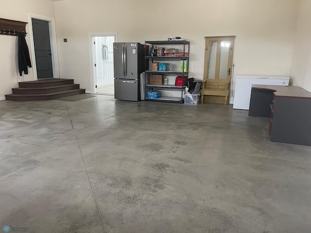 garage with stainless steel refrigerator