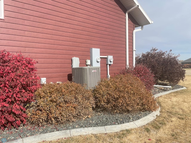 view of side of home with central air condition unit