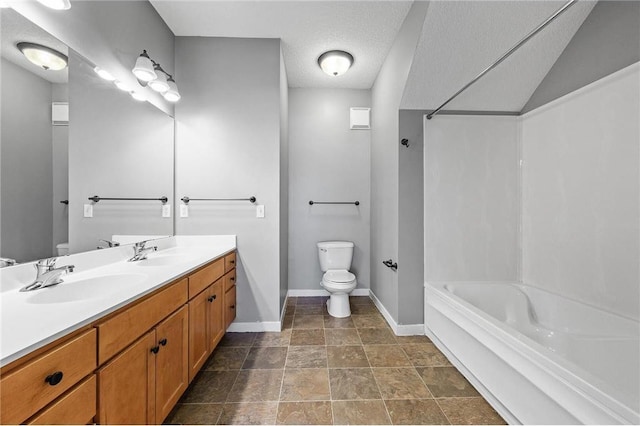 bathroom with vanity, a textured ceiling, and toilet