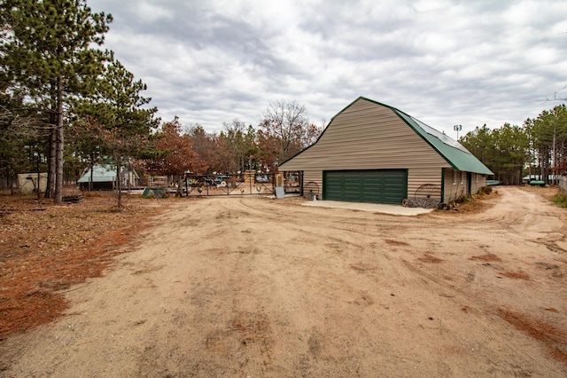 view of side of home featuring an outbuilding and a garage