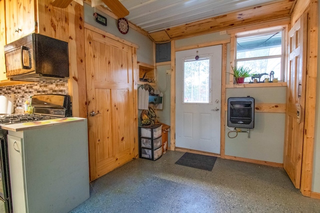 interior space featuring heating unit, white range with gas cooktop, and decorative backsplash