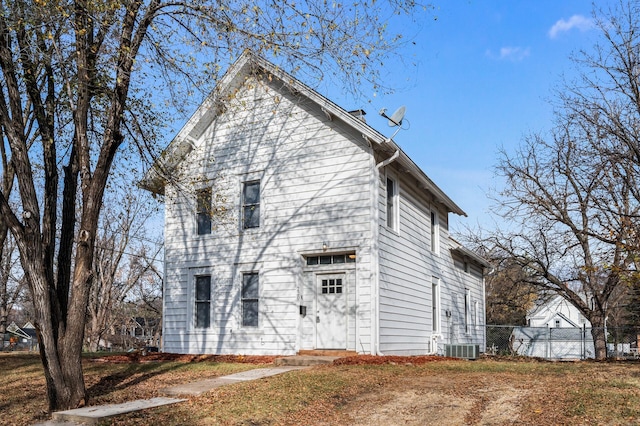 back of house featuring cooling unit