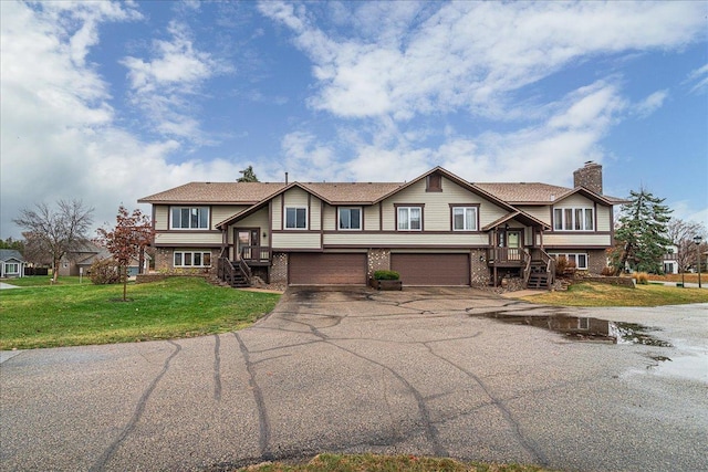 view of front of property featuring a garage and a front yard