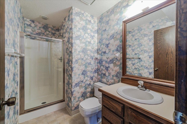 bathroom with vanity, a shower with shower door, a textured ceiling, and toilet