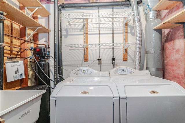 washroom with independent washer and dryer and sink