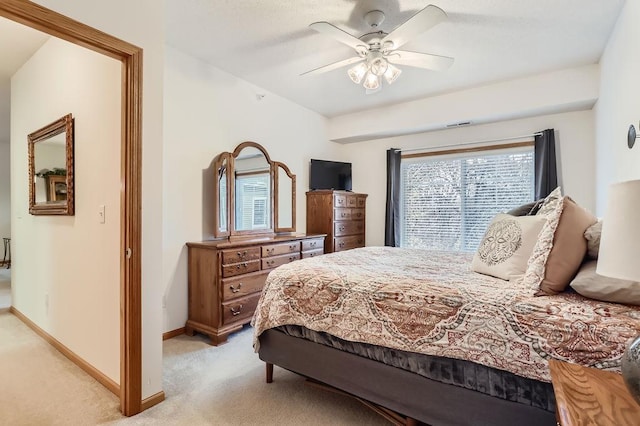 bedroom with ceiling fan and light carpet