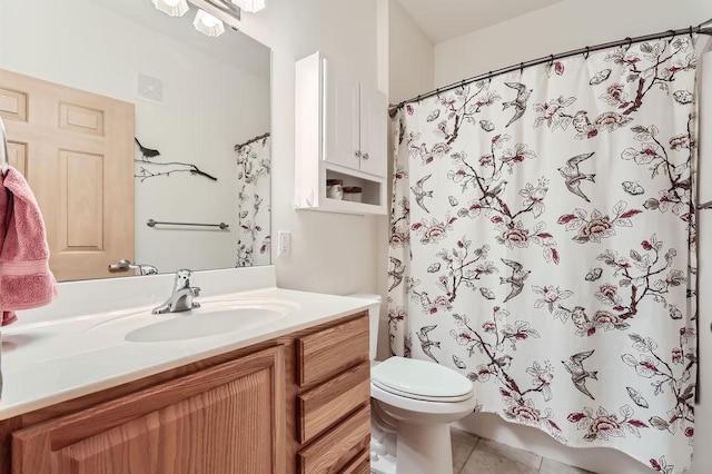 bathroom with tile patterned flooring, vanity, and toilet