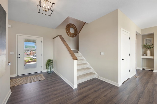 entrance foyer with a notable chandelier and dark hardwood / wood-style floors