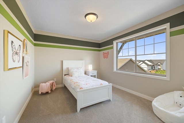 bedroom featuring light carpet and a textured ceiling