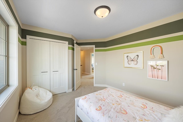 carpeted bedroom featuring a closet