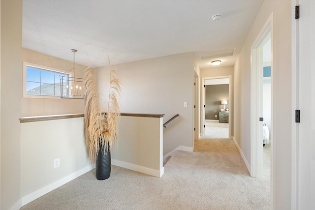 hallway featuring light colored carpet