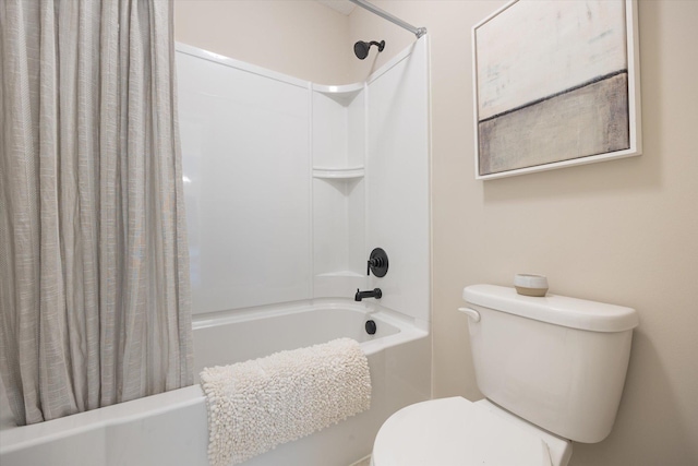 bathroom featuring shower / bath combination with curtain and toilet