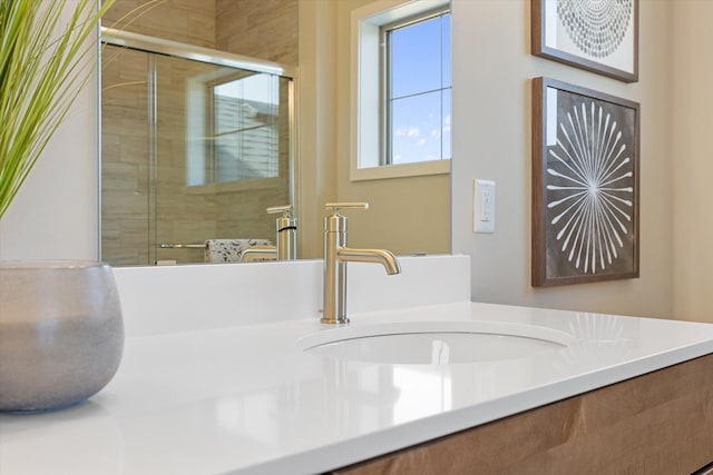 bathroom with vanity and a shower with door