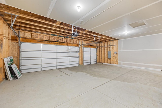 garage featuring a garage door opener and electric panel