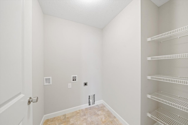 washroom featuring hookup for a washing machine, electric dryer hookup, and a textured ceiling