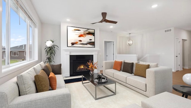 living room featuring light hardwood / wood-style floors and ceiling fan