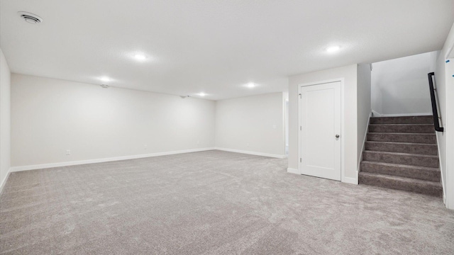 basement featuring light carpet