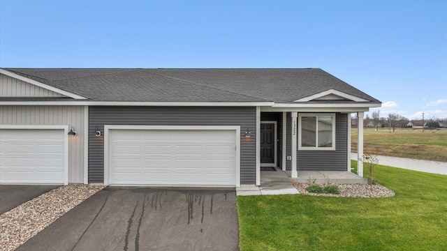 ranch-style house with a garage and a front yard