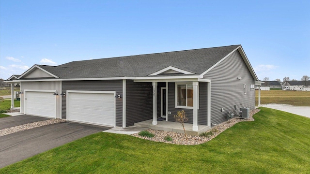 view of front of property with central AC unit, a garage, a front yard, and a porch