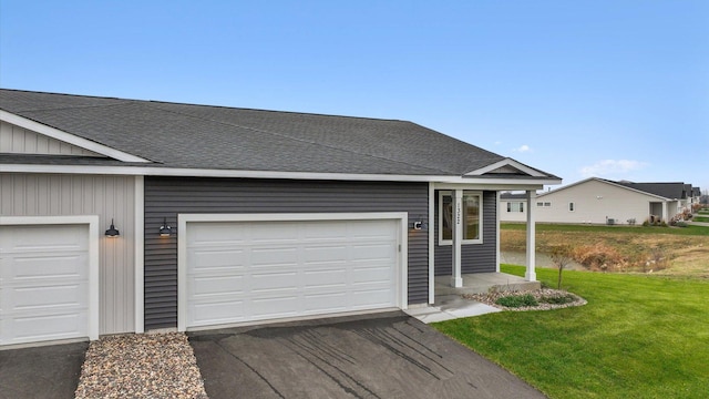 ranch-style home with a garage and a front lawn