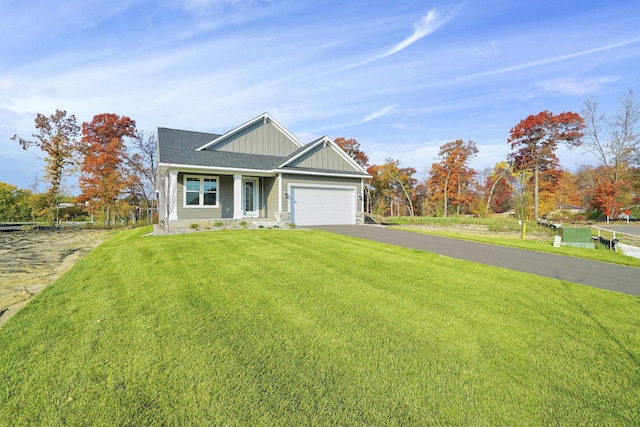 craftsman inspired home featuring a garage and a front lawn