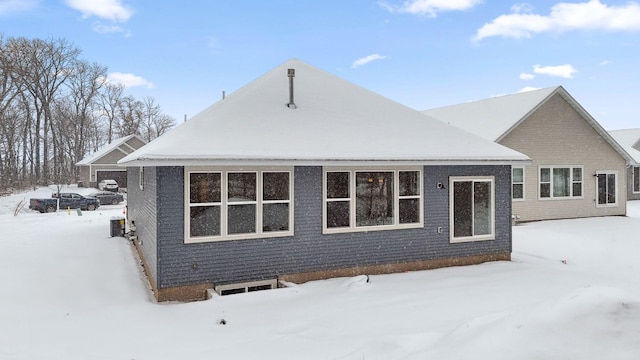 view of snow covered rear of property