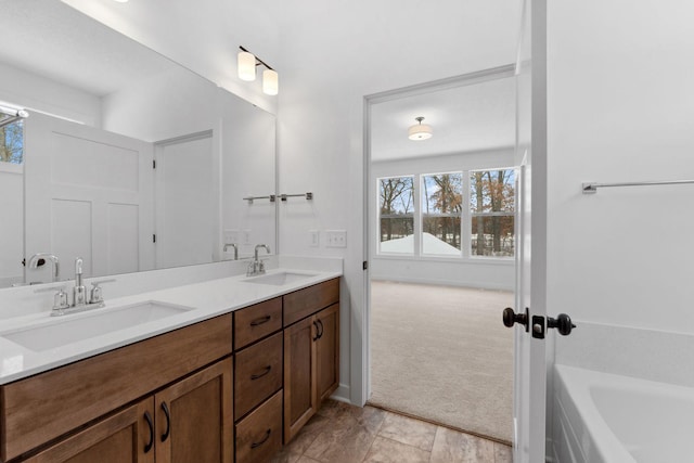 bathroom with vanity and a bath