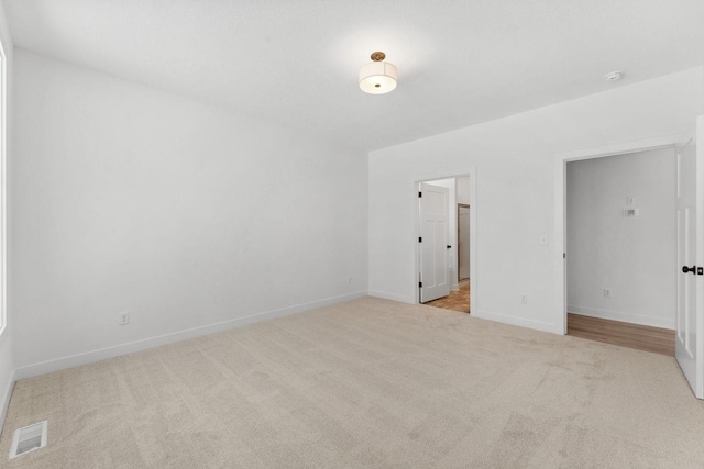 unfurnished bedroom with light colored carpet