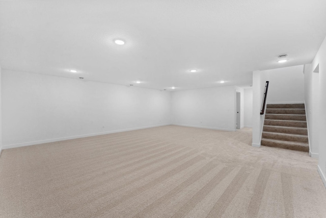 basement featuring light carpet