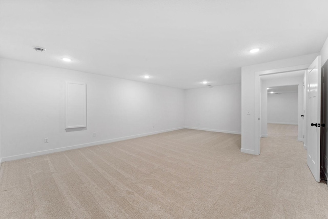 basement featuring light colored carpet