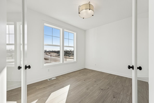 spare room featuring light hardwood / wood-style floors