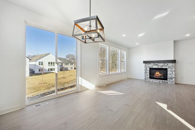 unfurnished living room with hardwood / wood-style floors and a fireplace