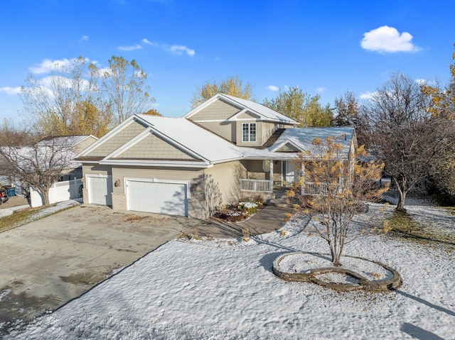 view of front of home with covered porch and a garage