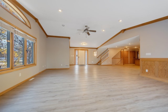 unfurnished living room featuring lofted ceiling, ornamental molding, light wood-type flooring, and ceiling fan