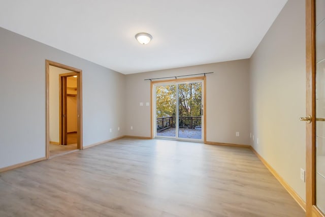 empty room with light hardwood / wood-style flooring