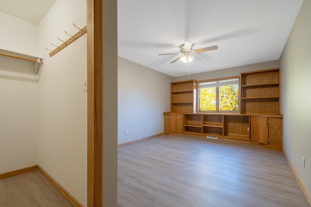 interior space with light wood-type flooring and ceiling fan