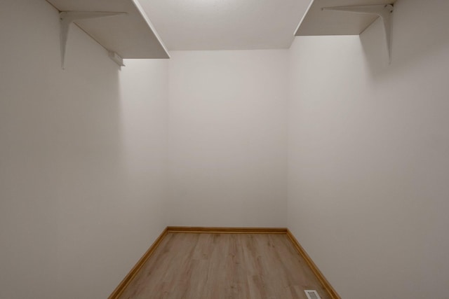 spacious closet featuring light hardwood / wood-style flooring