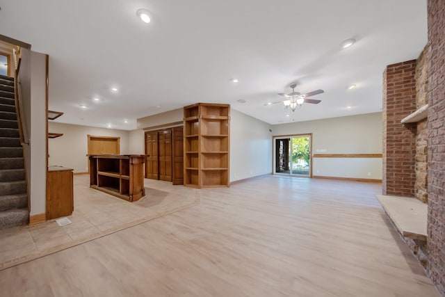 unfurnished living room with light hardwood / wood-style flooring and ceiling fan