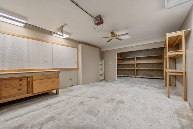 garage featuring a garage door opener, ceiling fan, and a workshop area