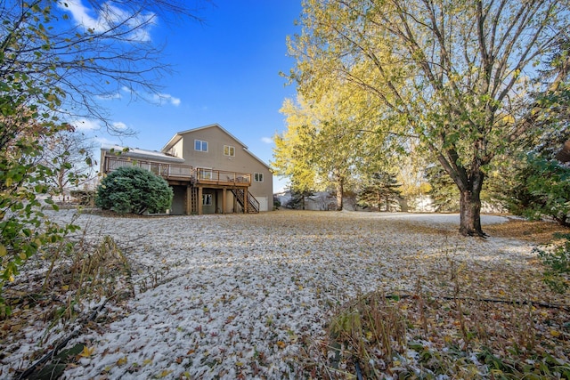 back of house featuring a wooden deck