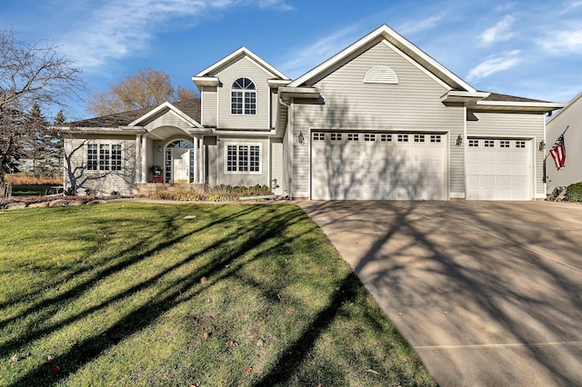 view of front of property featuring a front yard and a garage